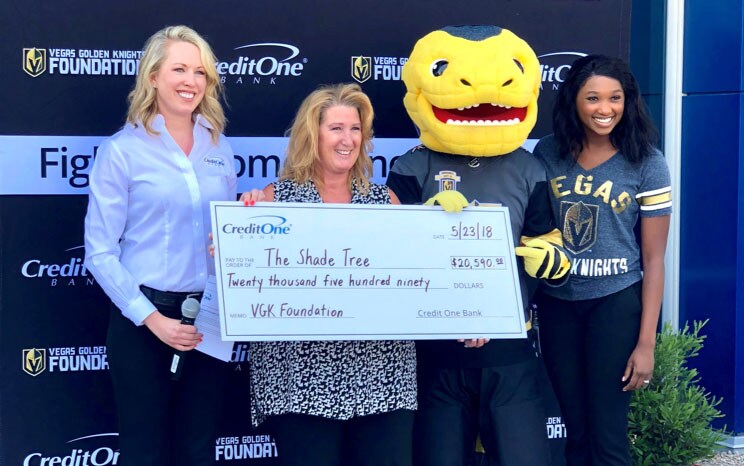 Individuals holding a giant check during a photo op