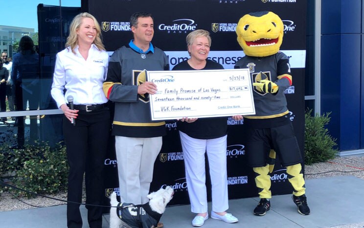 Individuals holding a giant check during a photo op