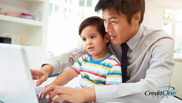 Father showing his infant son a budget on the computer