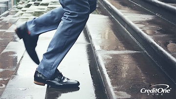 Business man quickly running up wet stairs