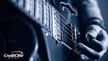 Closeup of a hand strumming a guitar