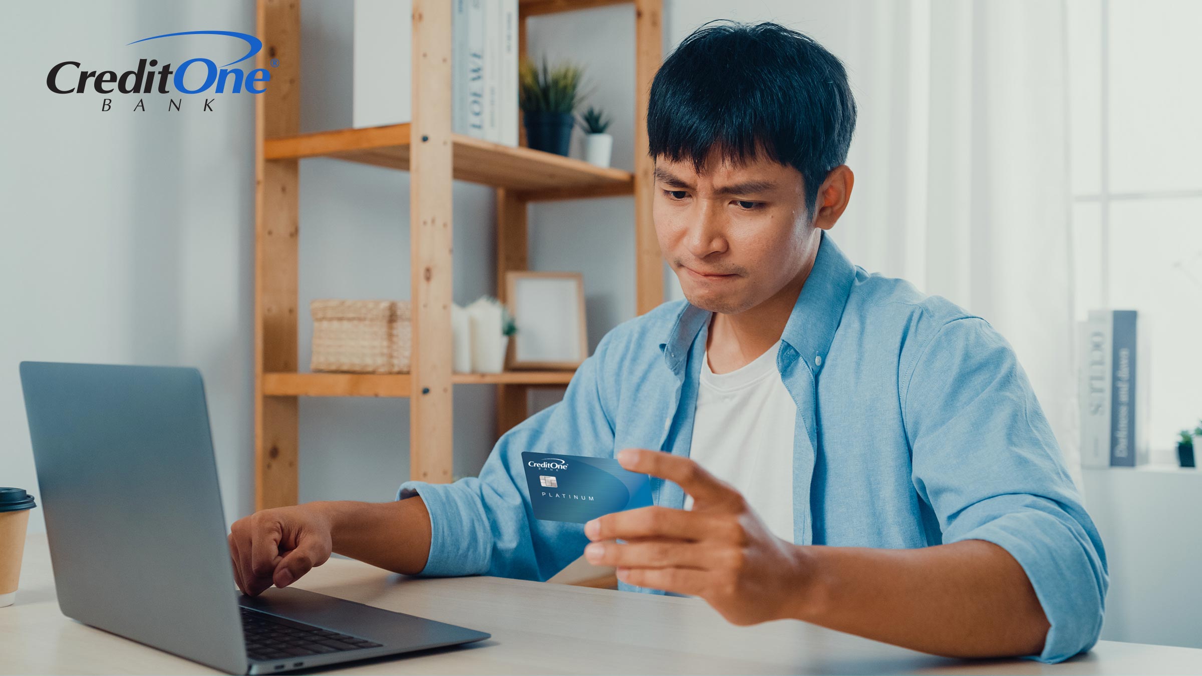 A man uses his laptop to log in to his account to see how much credit he currently has available on his credit card.