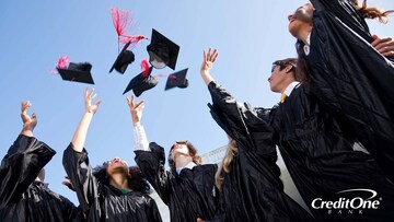 A group of high school students throw their caps in the air at their graduation ceremony, right before starting their job search.