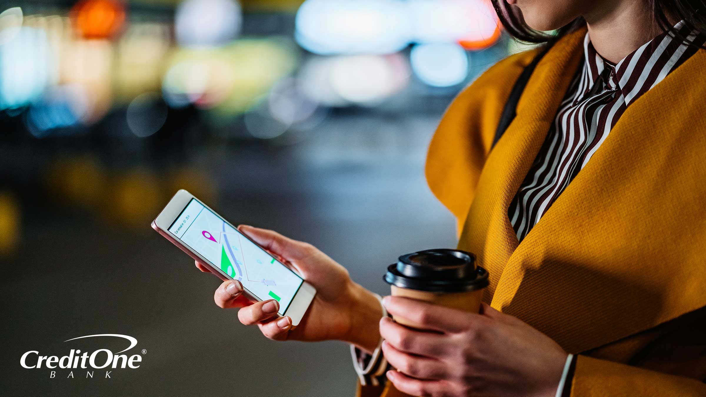 After finding the cheapest option available, a woman checks the status of her rideshare on her phone.