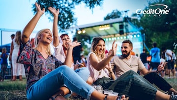 Several friends enjoy a music festival while earning perks from their entertainment rewards credit card