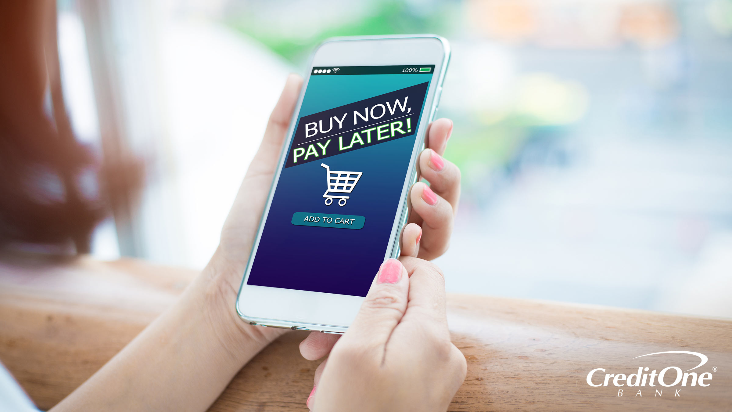 A woman shops on her phone, with the buy now, pay later option showing at the online checkout