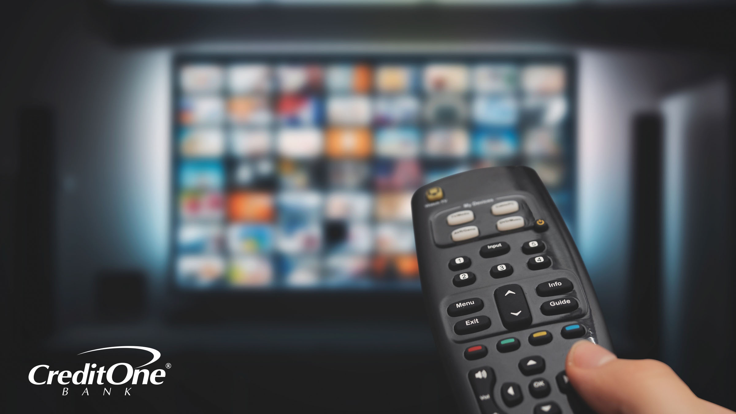 A man’s hand uses a remote to navigate various subscription services on a smart TV, which could impact his personal finances.
