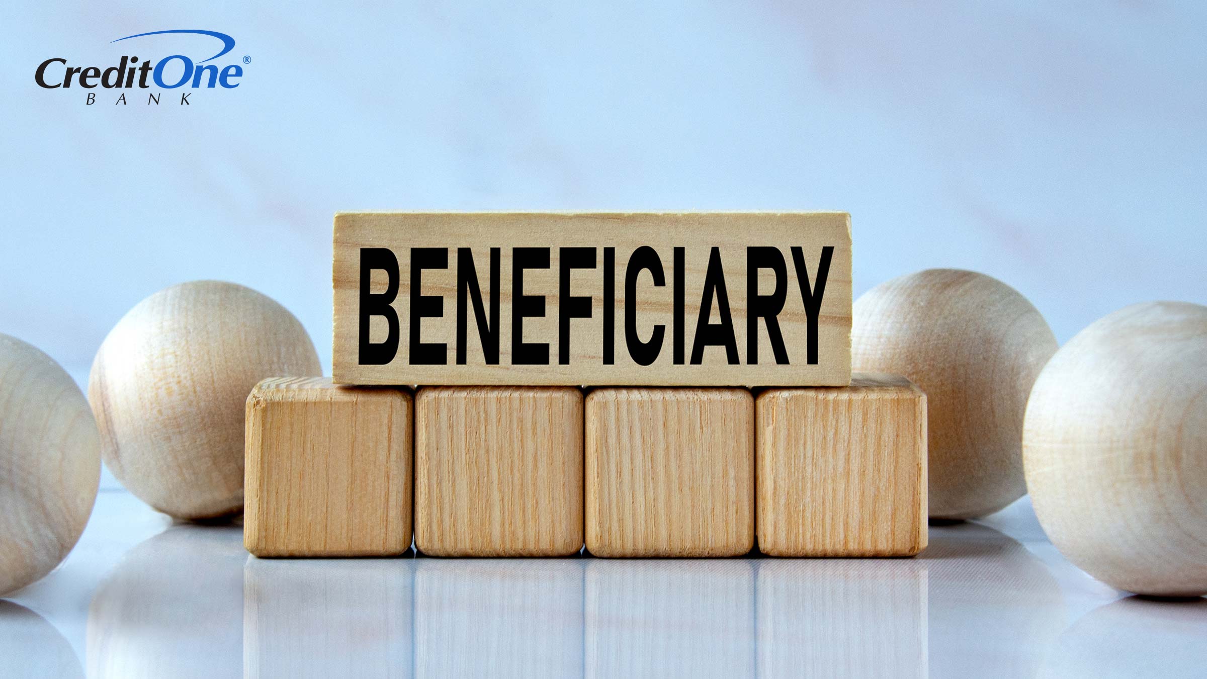 The word “beneficiary” is spelled out on a stack of wooden blocks representing the security-building benefits of adding a beneficiary.