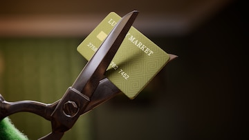 Credit Wrecker: Cancelina cutting a credit card with scissors 