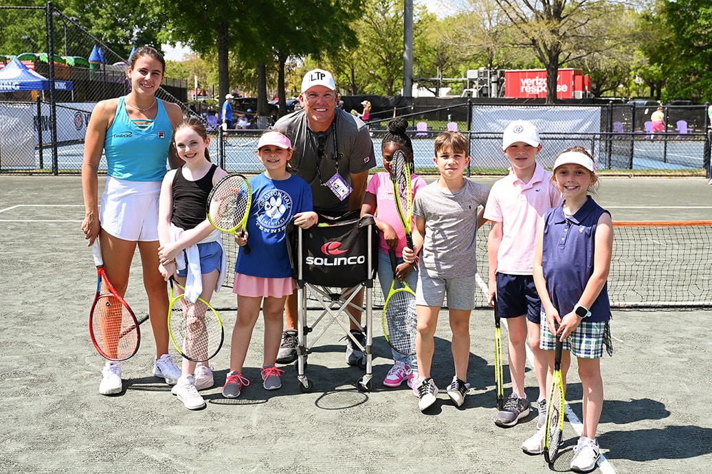 Tennis star Emma Navarro posing with students from Meeting Street Academy for ‘Number One Fan’ initiative at Credit One Charleston Open
