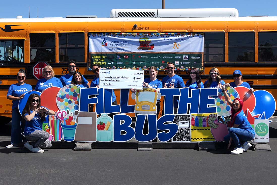 Credit One Bank Employees filling the school bus with back to school supplies.
