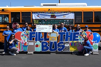 Credit One Bank Employees filling the school bus with back to school supplies.