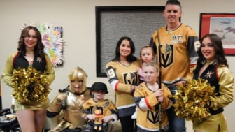 Two families from Candlelighters Childhood Cancer Foundation at the Vegas Golden Knights game with Credit One Bank