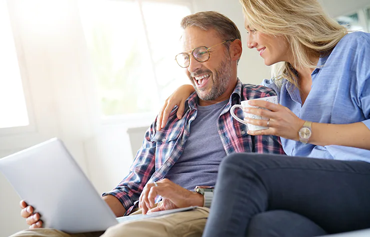 A Couple Looking At a Laptop Together