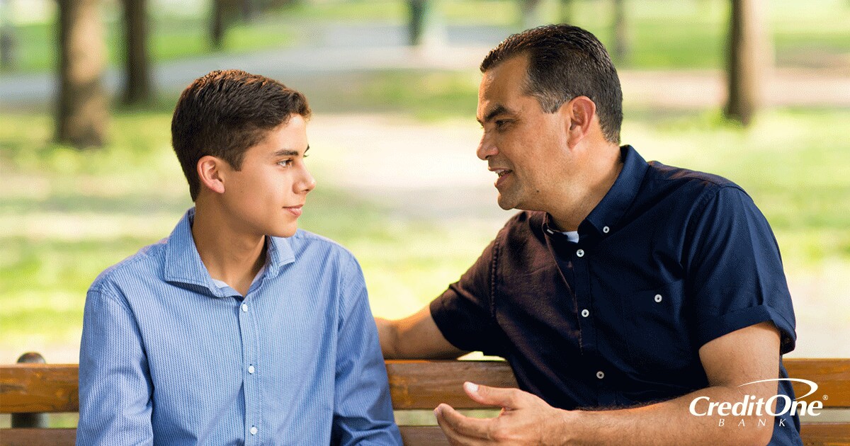 Father sharing financial advice with his son Father sharing financial advice with his son