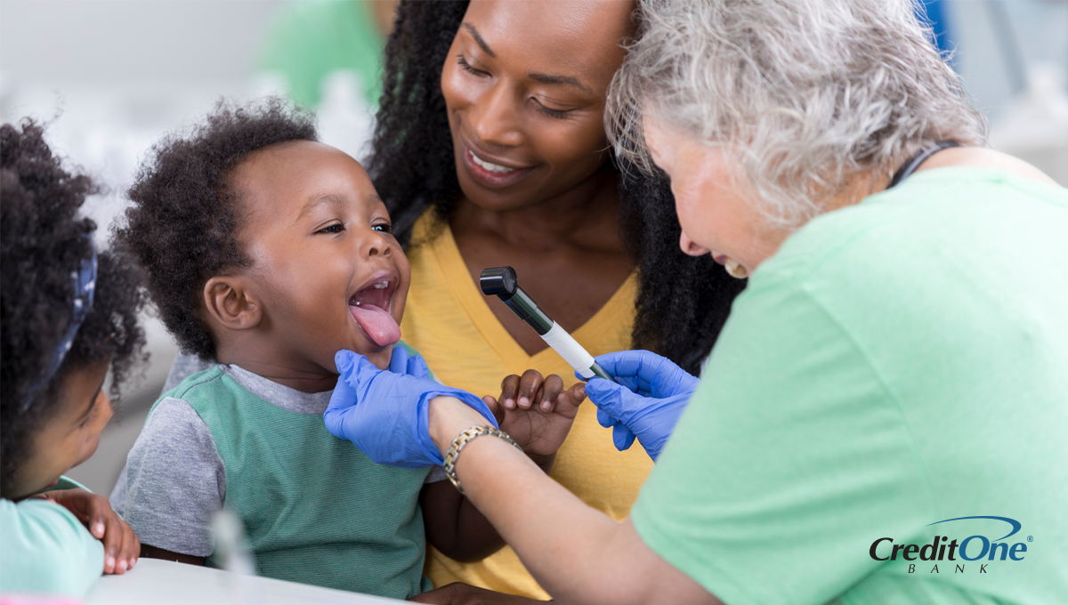 A mother using her health insurance to pay for a health checkup for her toddler A mother using her health insurance to pay for a health checkup for her toddler