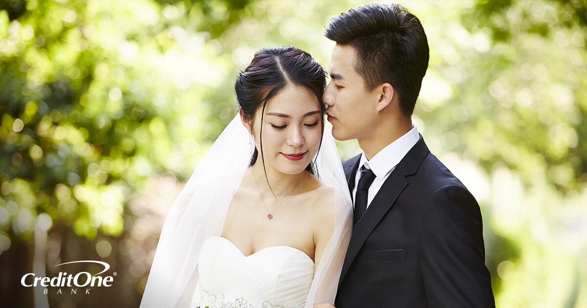 A young bride and groom embracing each other on their wedding day A young bride and groom embracing each other on their wedding day