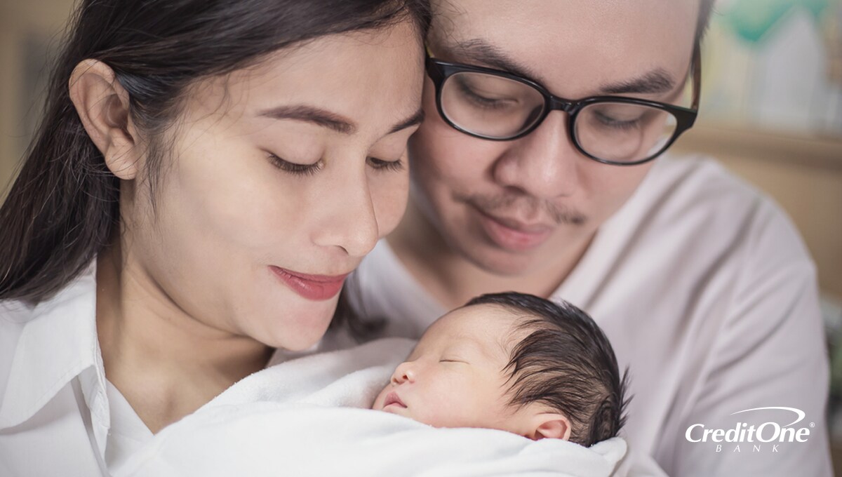 A father and mother holding their new born baby A father and mother holding their new born baby