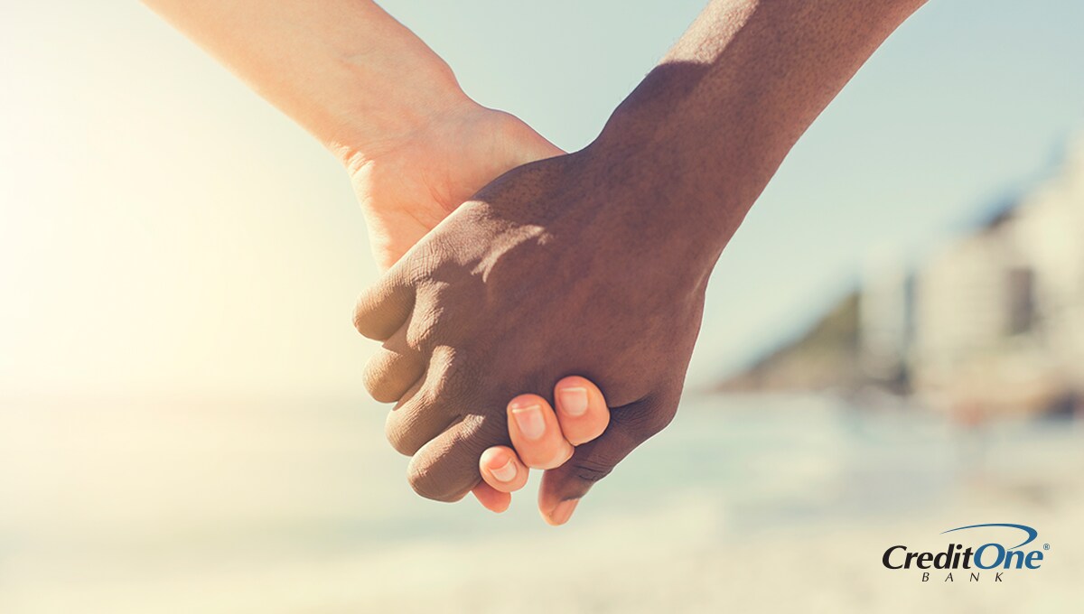 Two people holding hands demonstrating how income and credit come together Two people holding hands demonstrating how income and credit come together