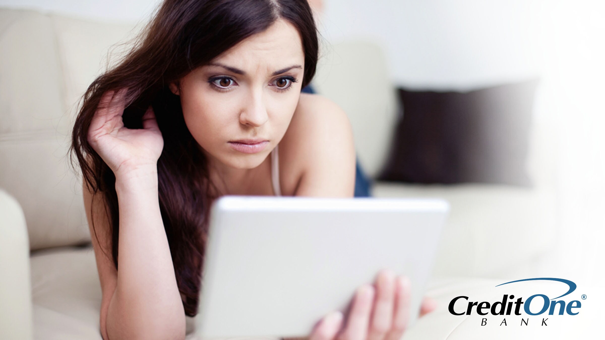 Woman reviewing her credit score and credit reports on tablet device Woman reviewing her credit score and credit reports on tablet device