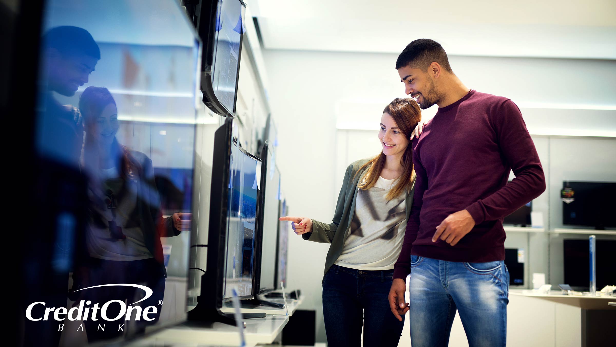 A couple browsing potential TV purchases A couple browsing potential TV purchases