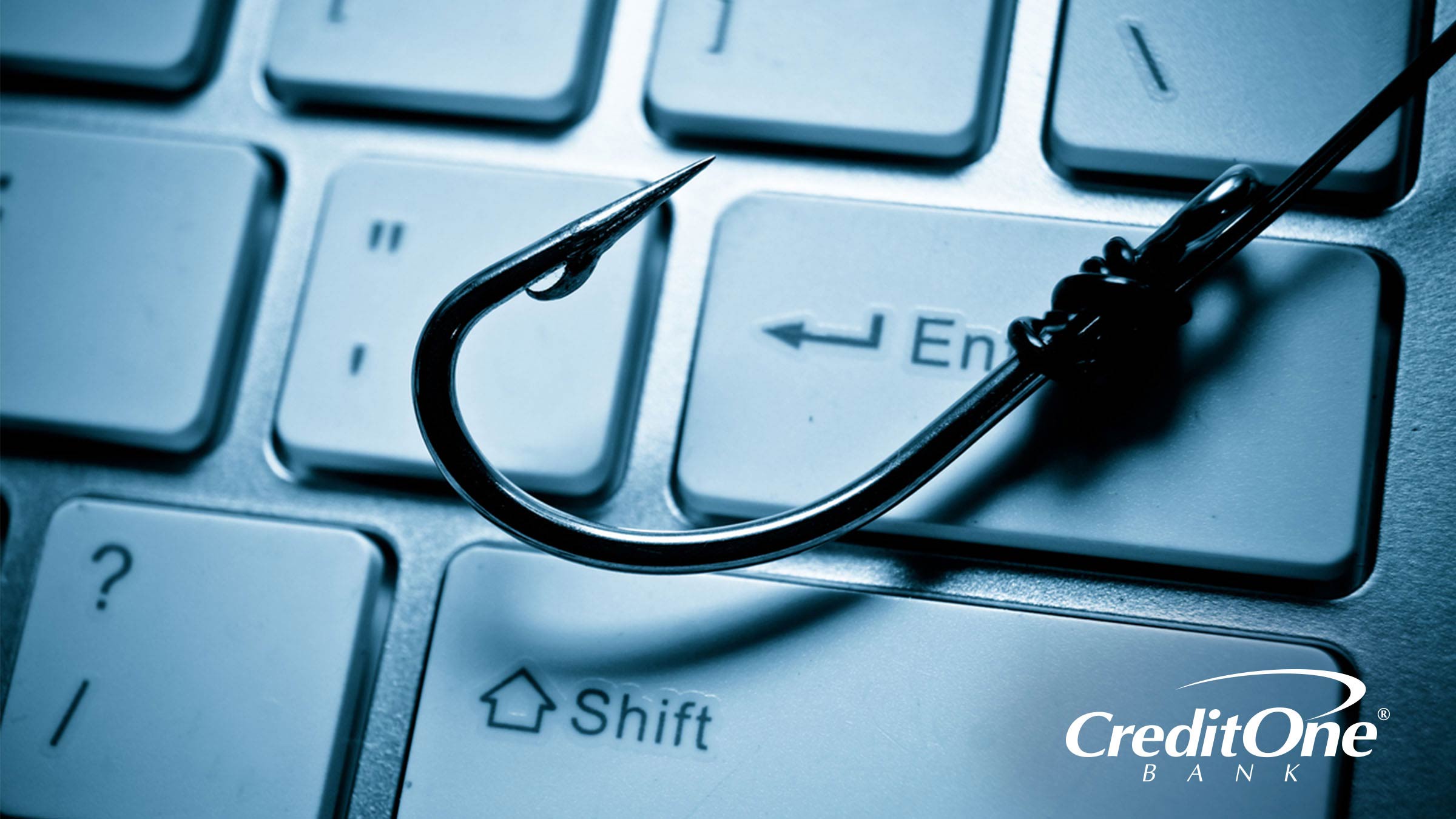 A fishing hook resting on a keyboard - don't get phished A fishing hook resting on a keyboard - don't get phished