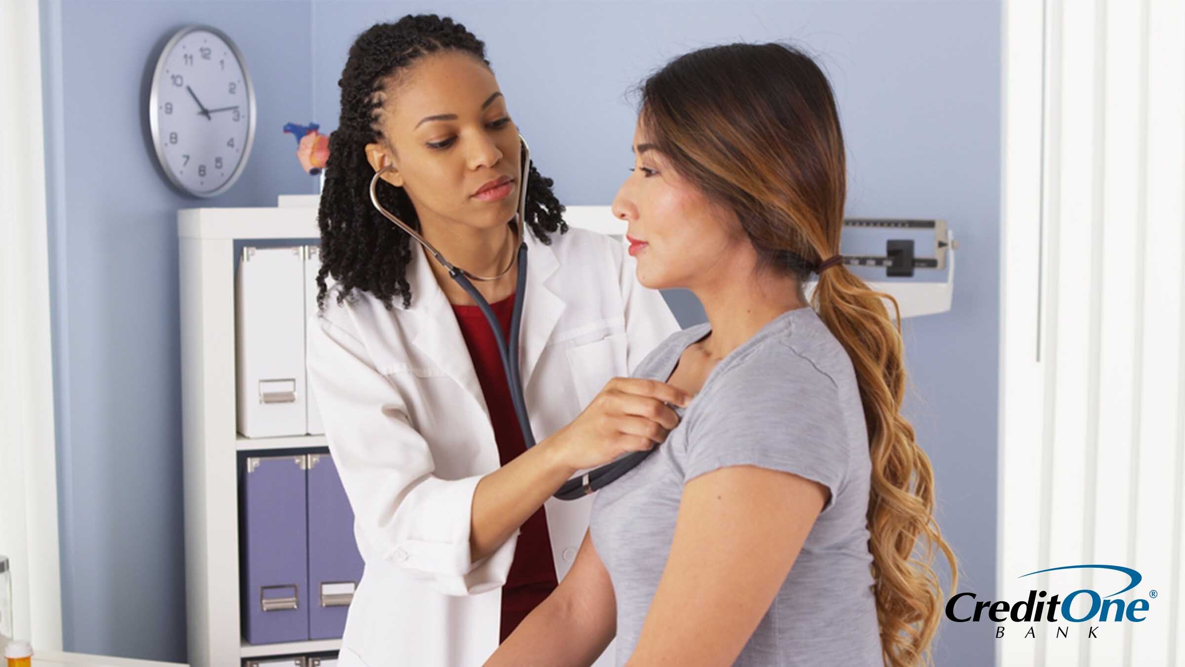 Woman using her health savings account to get a check-up by the doctor Woman using her health savings account to get a check-up by the doctor