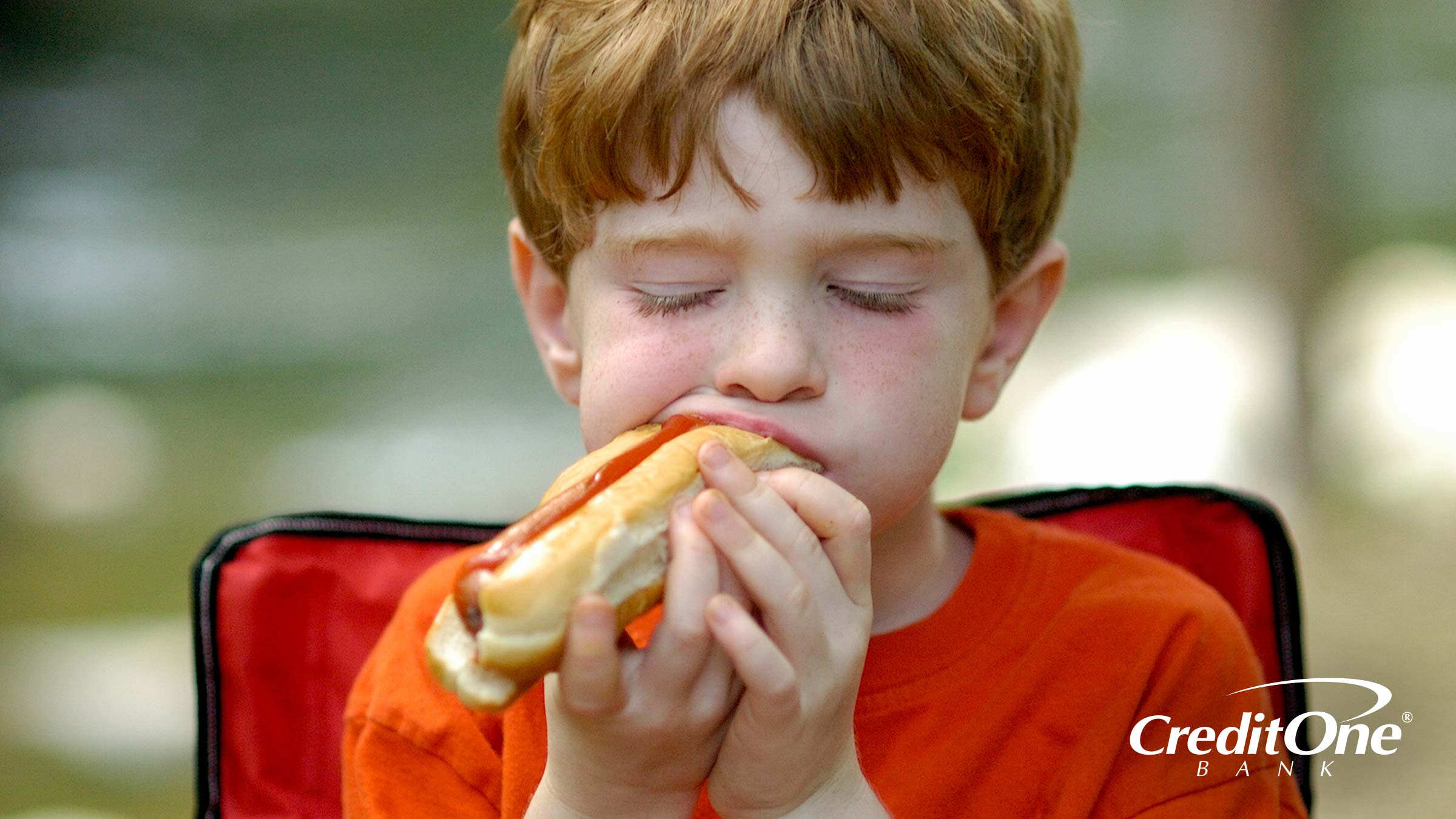 A Child Eating a Hot Dog