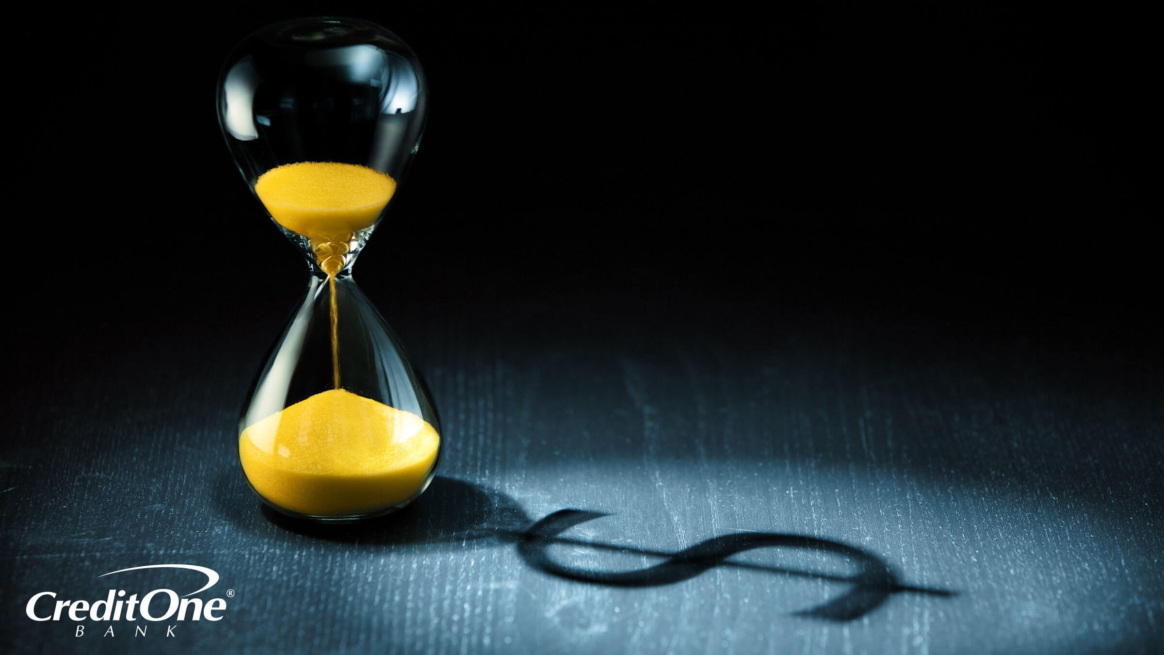 An hourglass projects the shadow of a dollar sign, signifying that a credit card has not been used in a long time. An hourglass projects the shadow of a dollar sign, signifying that a credit card has not been used in a long time.