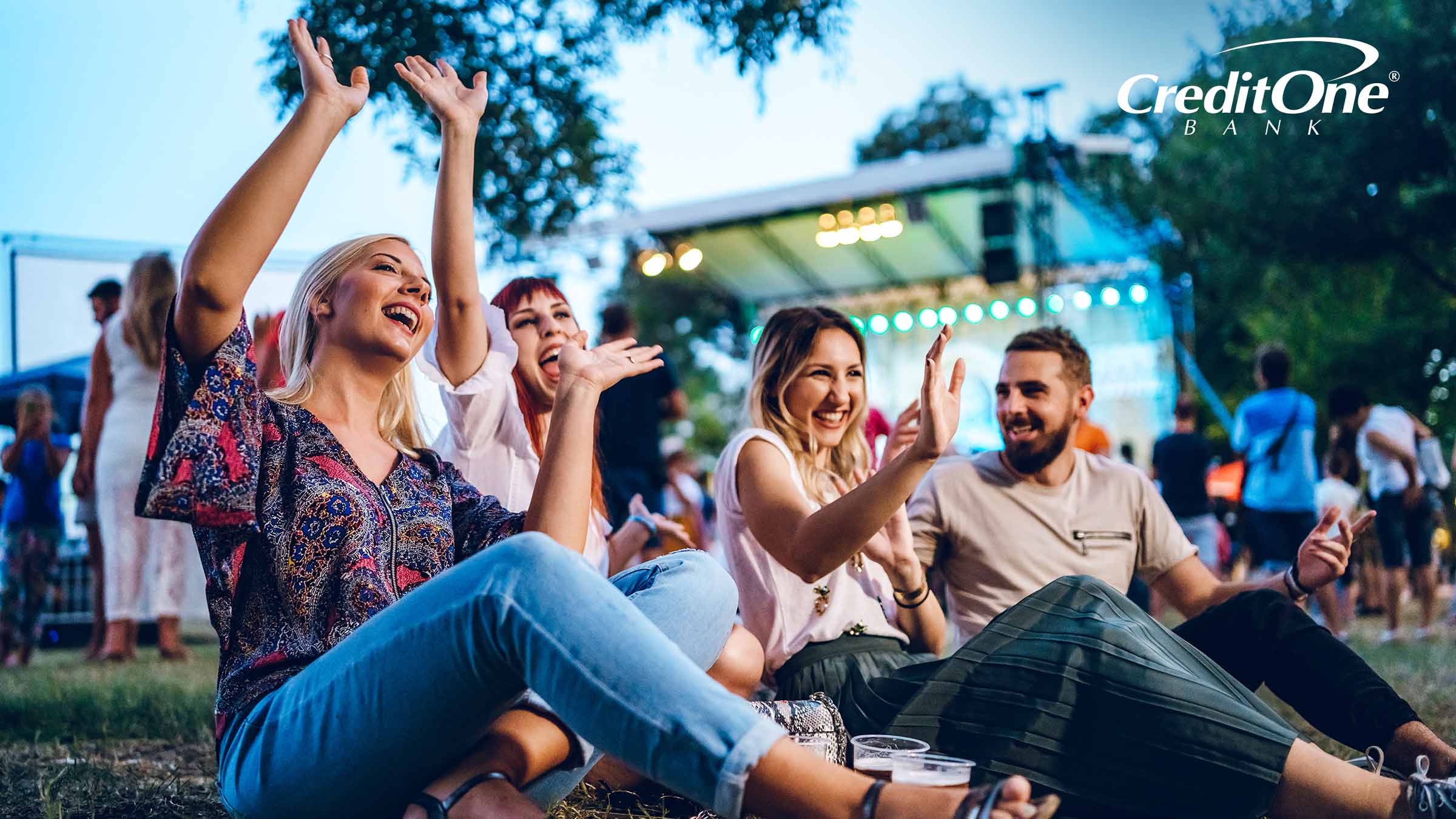 Several friends enjoy a music festival while earning perks from their entertainment rewards credit card