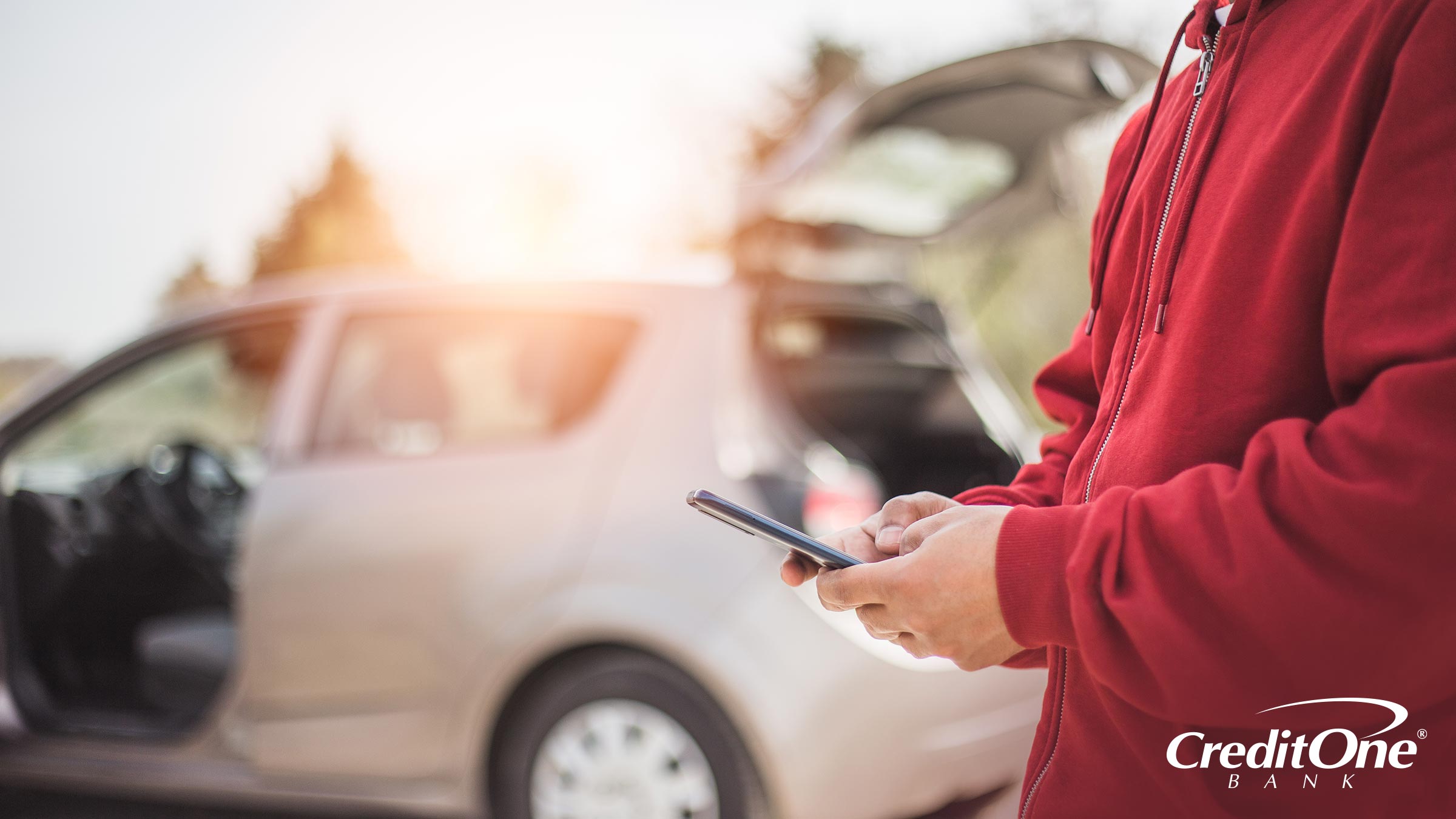 After crashing a family member’s car, a man uses his cell phone to look up whether his car insurance policy follows him or his car. After crashing a family member’s car, a man uses his cell phone to look up whether his car insurance policy follows him or his car.
