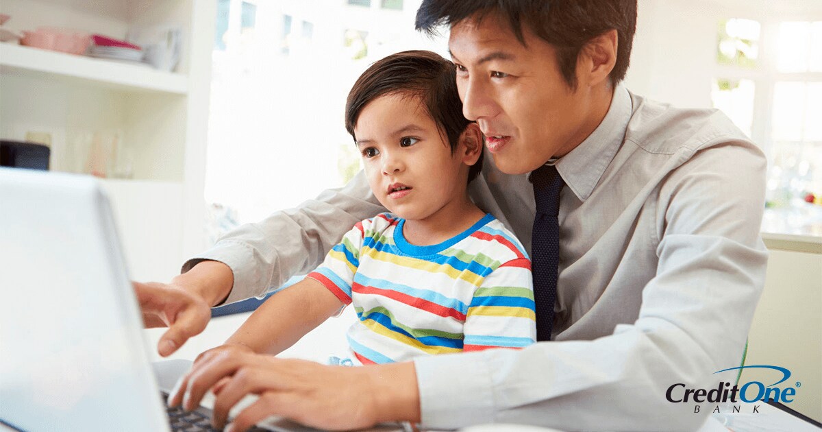 Father showing his infant son a budget on the computer Father showing his infant son a budget on the computer
