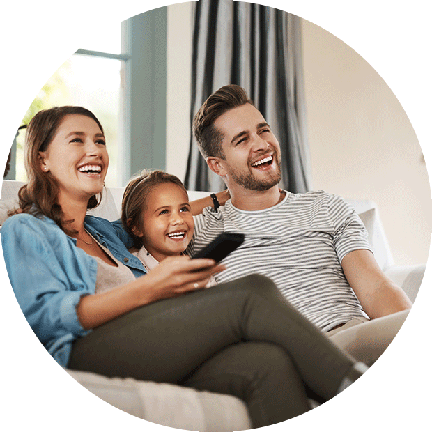 Man, woman, and child watching television