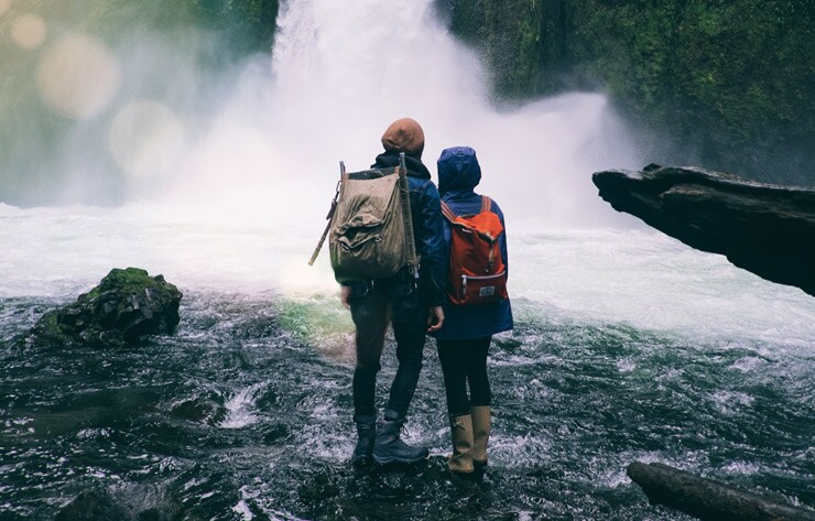 A Couple Standing at a Waterfall