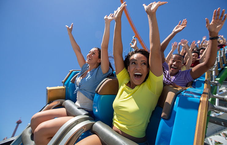 People Waving Their Hands on a Rollercoaster