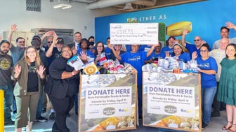 Credit One Bank employees and representatives from U.S.VETS - Las Vegas pose with donations from Bank employees.