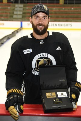 Deryk Engelland holding a set of Vegas Golden Knight credit cards from Credit One Bank
